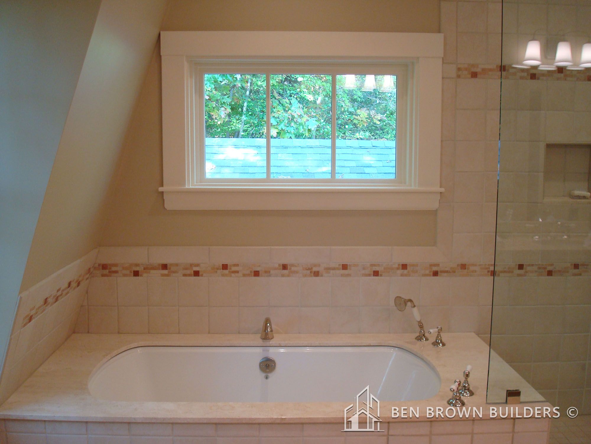 Chic bathroom with a navy blue vanity, double sinks, two framed mirrors, and vintage-style wall sconces